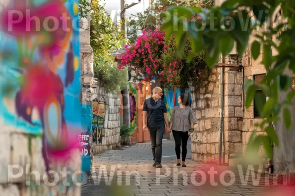 זוג מטייל יד ביד ברחובותיה העתיקים של צפת, ממדינת ישראל. צמח, אנשים בטבע, פְּנַאִי